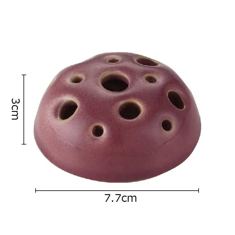 A purple lotus seedpod ceramic incense burner with multiple circular holes for modern living room decor