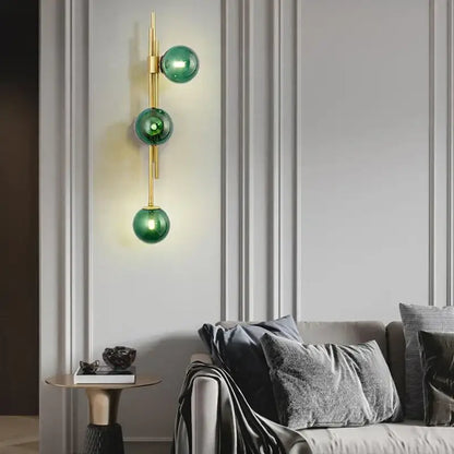Modern emerald green white glass wall lamp with three stacked spheres and gold-toned metal accents for bedroom decorbites green white