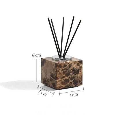 Brown emperador dark marble cube diffuser with six black reed sticks from modern bathroom set with chrome accents