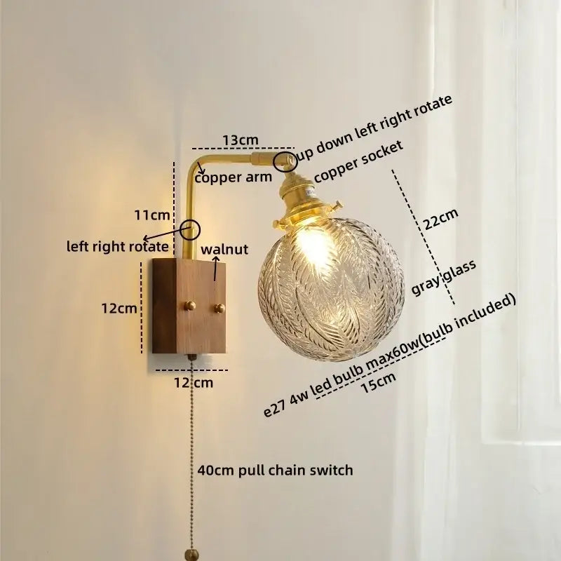 Modern etched glass copper led wall lights with a brass copper arm and walnut base featuring an ornate glass globe bulb