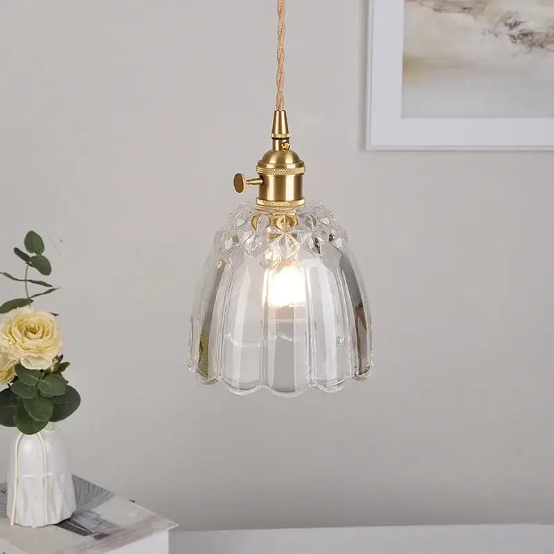 Modern faceted clear glass pendant lamp with brass fixture and braided cord featuring a knob switch by decorbites clear glass