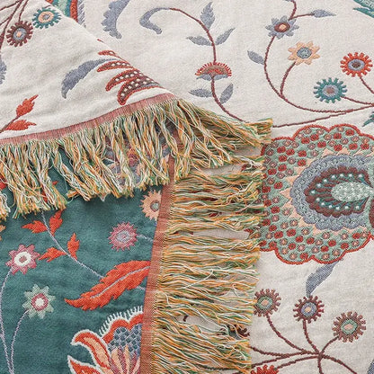 A cozy decorbites cooling cotton blanket with vibrant teal coral floral pattern and multicolored fringe on cream background