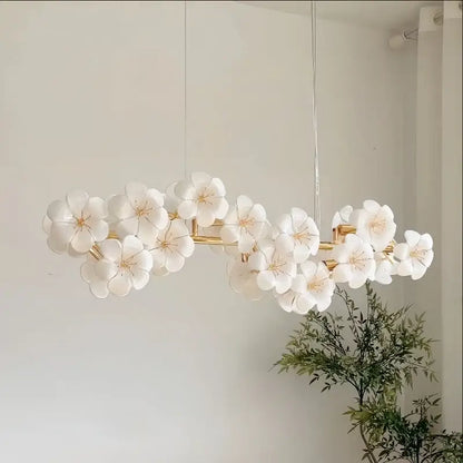 Elegant white ceramic flower pendant light with gold-toned metal finish for practical illumination in kitchens