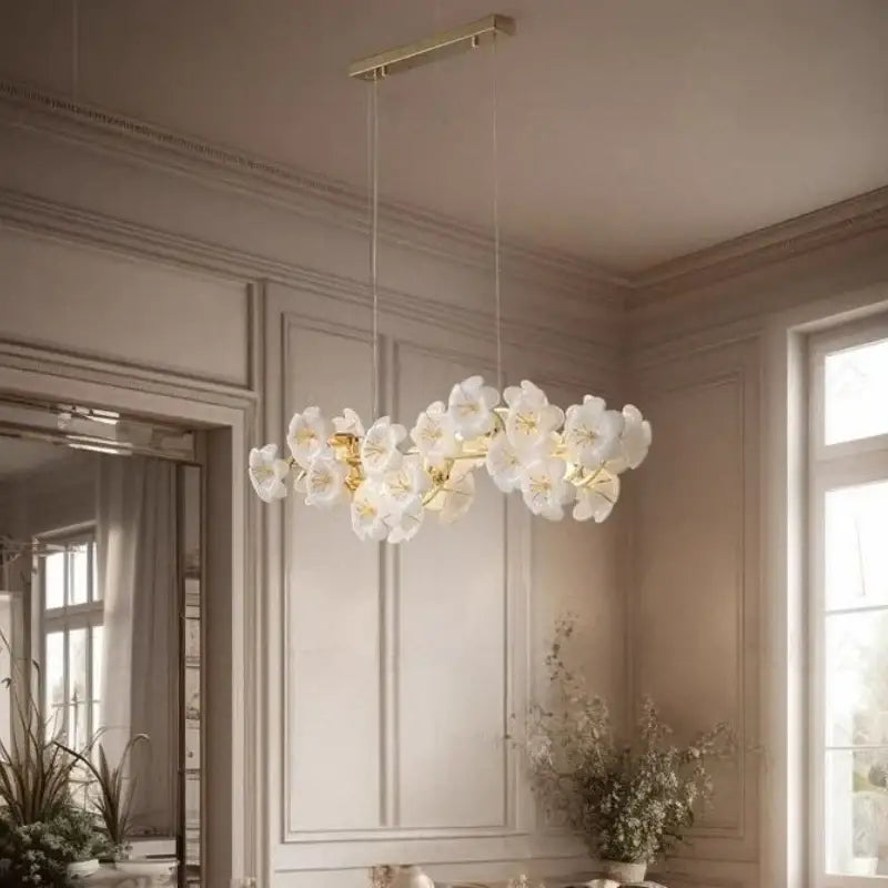 Elegant white floral pendant light with gold-toned metal finish offering practical illumination for kitchen spaces