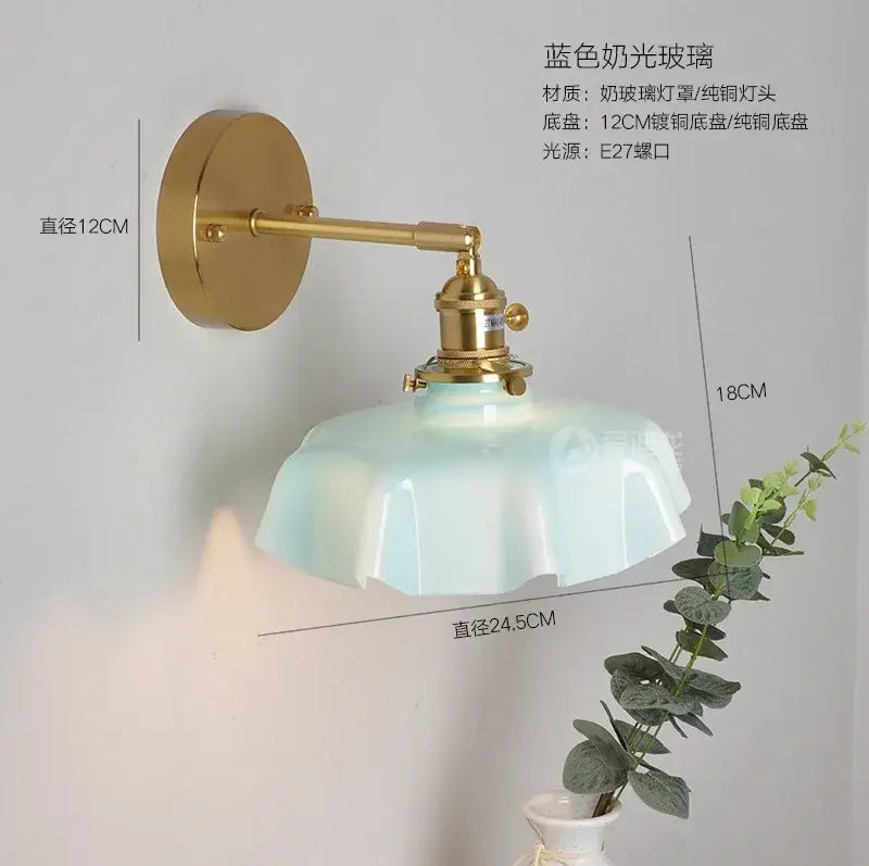 Modern blue frosted glass pendant light with fluted petal design on polished brass arm for dining room lighting