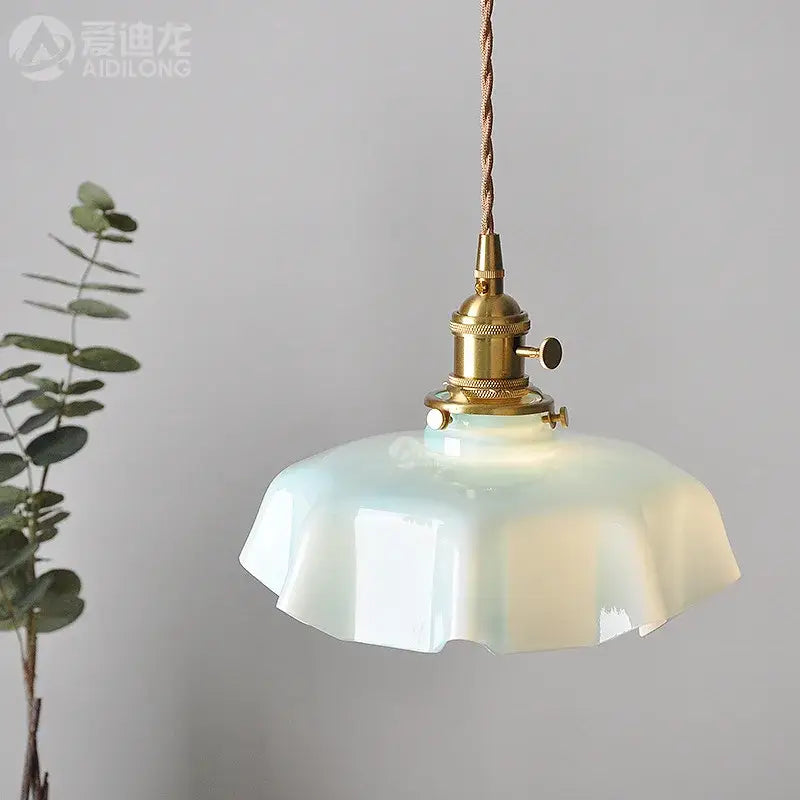 Modern cream glass pendant lights with fluted design featuring a delicate mint-green glass pendant and brass fixture