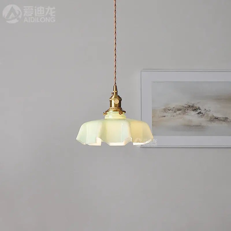 Modern fluted cream glass pendant light with brass fixture and twisted cord for dining room pendant lights