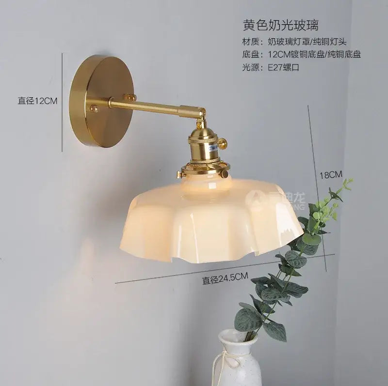 A vintage-style wall-mounted lamp with golden brass finish and yellow frosted glass shade for pendant lights decor