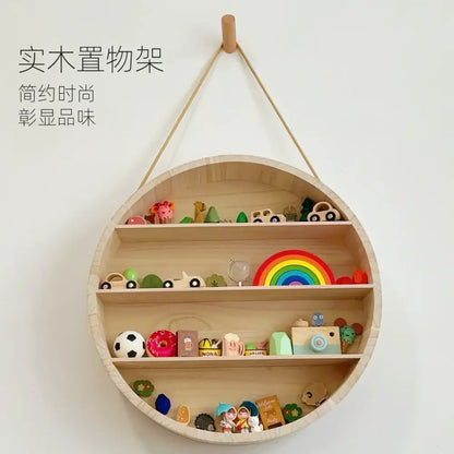 Modern four tier circular wooden frame living room wall shelf in light wood with colorful children’s toys on three tiers