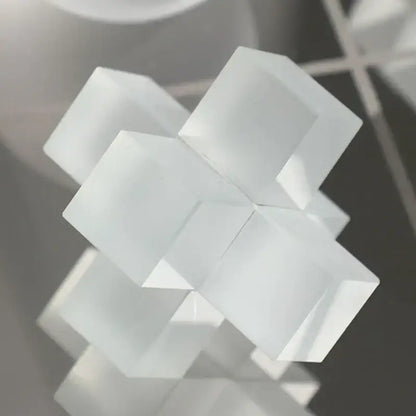 A translucent white decorbites frosted glass geometric tic tac toe set with interlocking cubic elements for living room decor