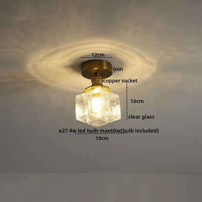 A vintage-style ceiling light with brass iron base copper socket and clear faceted glass shade for elegant lighting