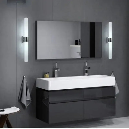 Modern frosted glass led wall lamp in gold silver and black above a black glossy vanity with white sink and chrome faucets
