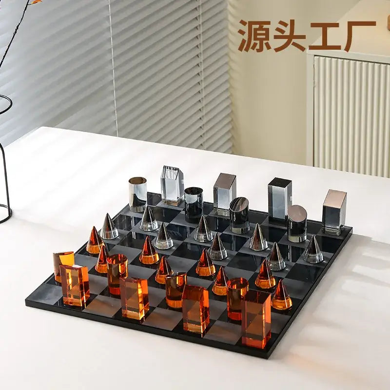 Modern geometric amber and silver glass chess set with translucent pieces on sleek black board for home decor