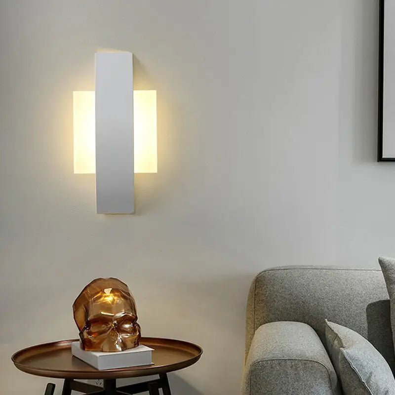 Modern white rectangular led wall sconce with warm glowing light for stylish living room illumination