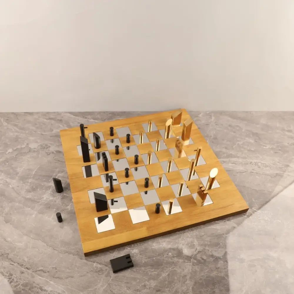 Modern geometric block chess set with black and gold metallic pieces on wooden board for living room decorbites decor