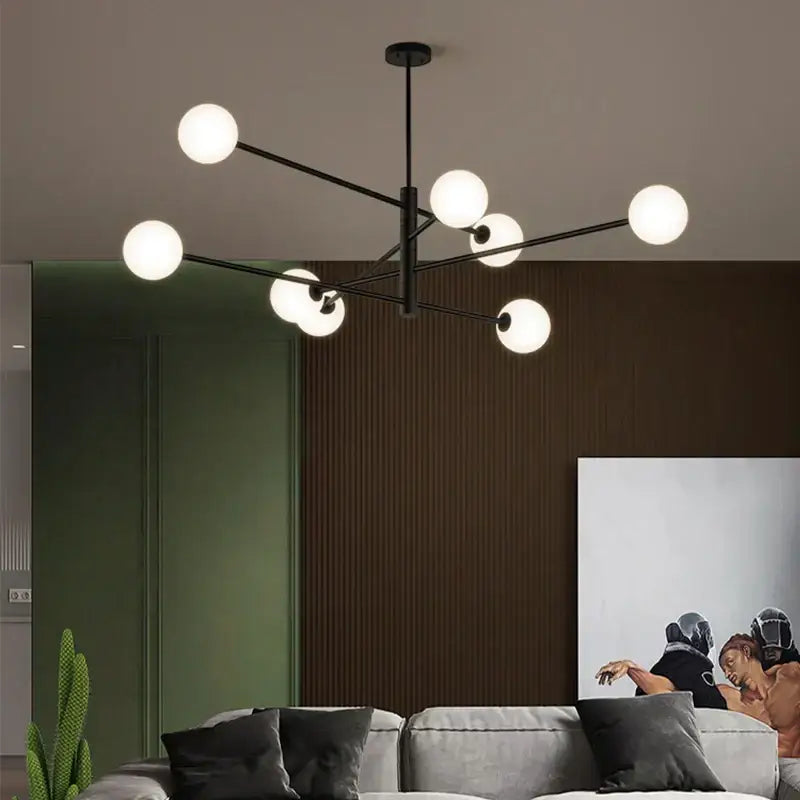 Modern geometric decorbites brass chandelier with black metal frame and frosted glass globe lights for living room decor
