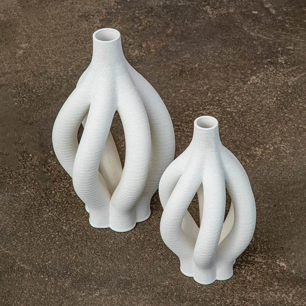 White geometric ceramic spiral vases with intricate twisted design for modern living room decor by decorbites