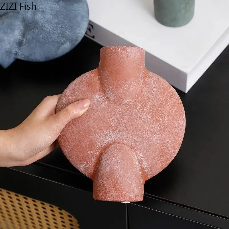 Terracotta colored decorbites geometric ceramic vase with textured matte finish and abstract organic shape for living room decor