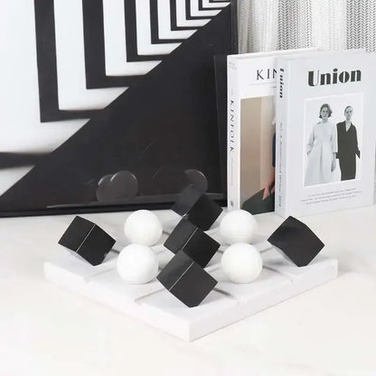 Modern geometric chess ornament set in black and white on a minimalist white base for stylish home decor