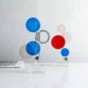 Modern geometric crystal circle sculpture with translucent blue red and beige spheres on clear acrylic rods for home decor