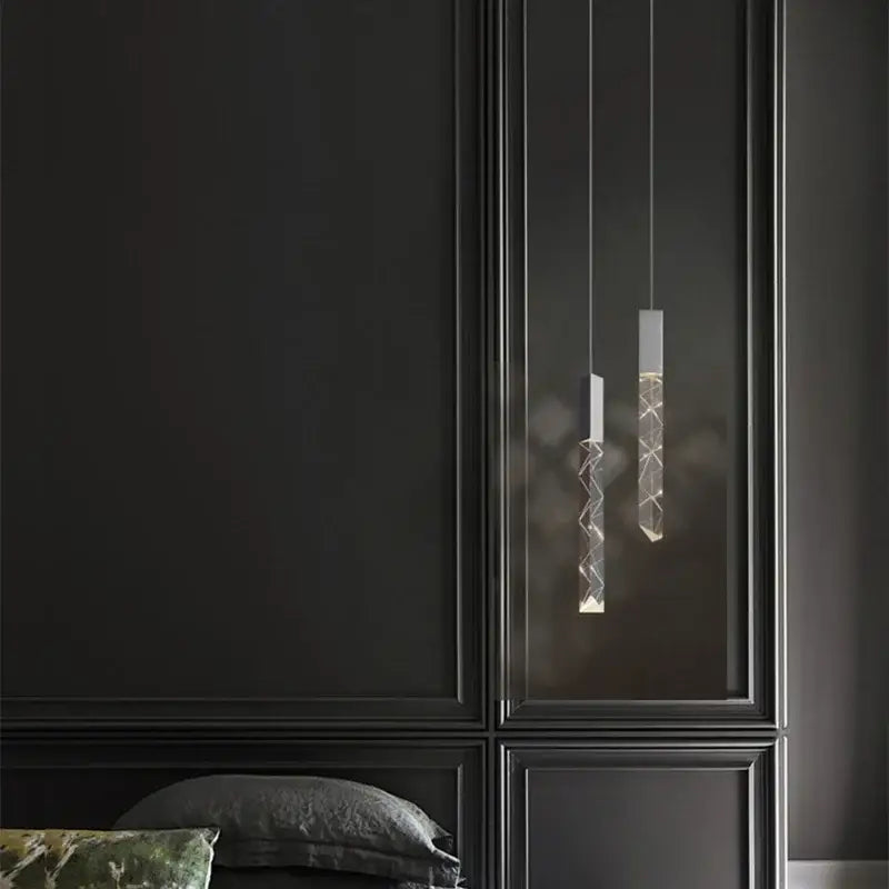 Two modern minimalist pendant lights with decorbites crystal glass and geometric etched patterns for living room decor