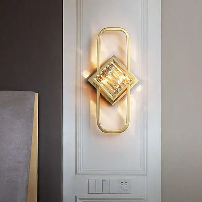 Modern geometric crystal gold wall lamp with a gold-toned frame and faceted crystal centerpiece for living room decorbites crystal gold