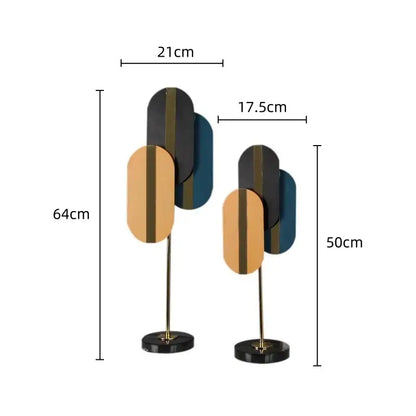 Modern geometric ellipse metal sculpture with layered black gold and teal panels on polished brass stand for home decor by decorbites