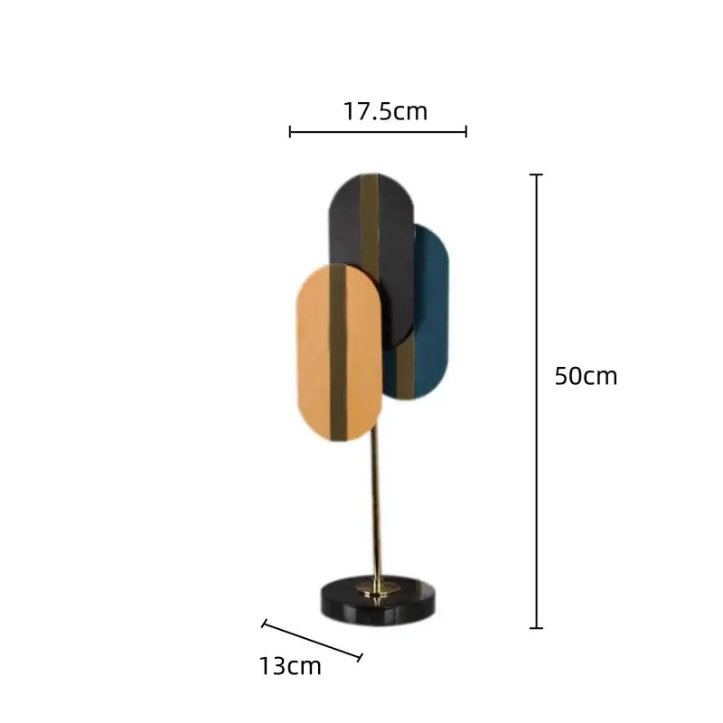 Modern geometric ellipse metal sculpture with matte black, warm gold, and deep teal panels for home decor decorbites geometric ellipse