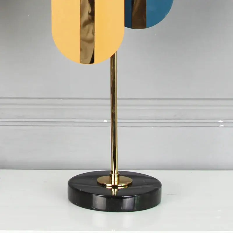 Modern abstract table lamp with gold-toned metal stem and vibrant yellow blue bronze panels for home decor geometric ellipse metal