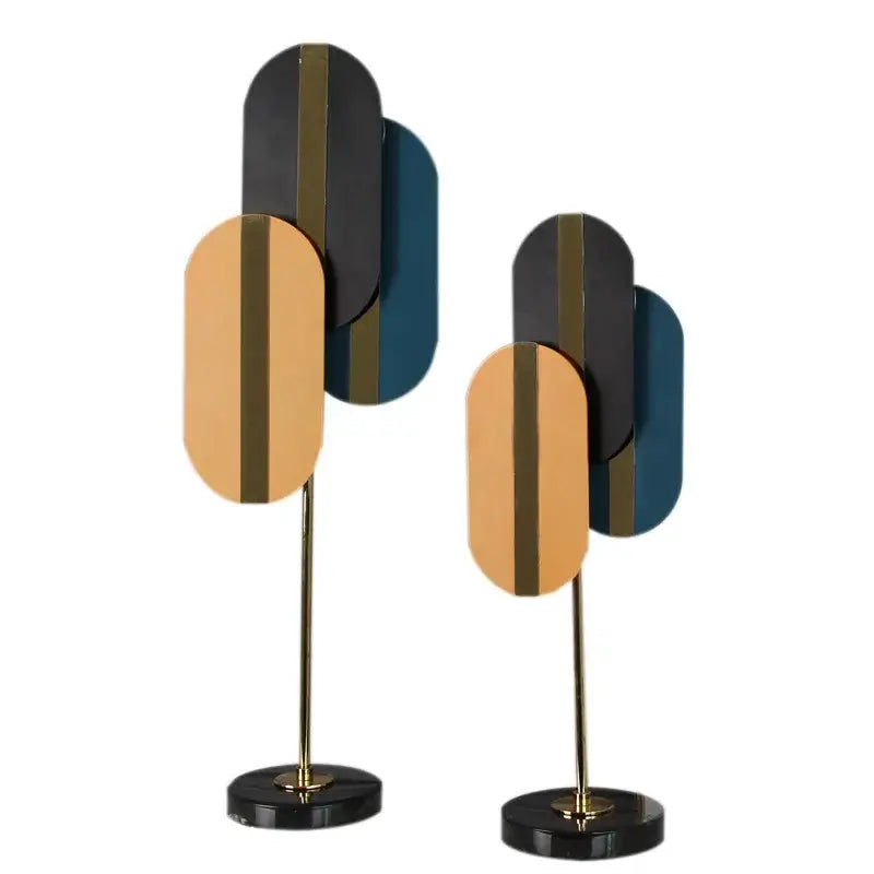 Modern geometric ellipse metal sculpture with layered black gold and teal panels on brass stems for home decor decorbites geometric ellipse