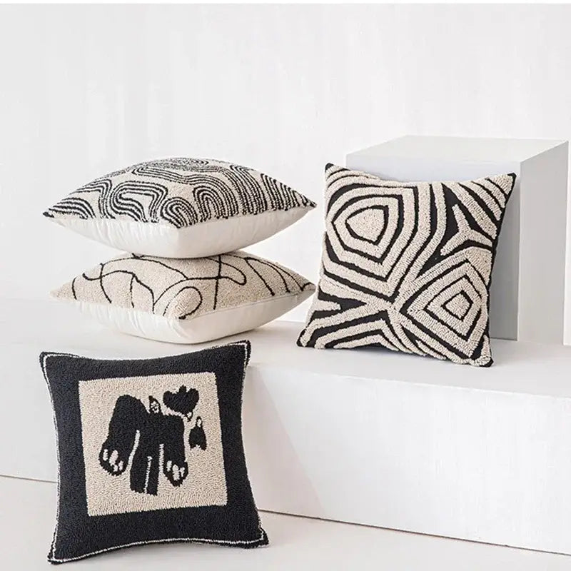Black and cream modern geometric embroidered cushion cover with abstract geometric and animal motifs decorbites
