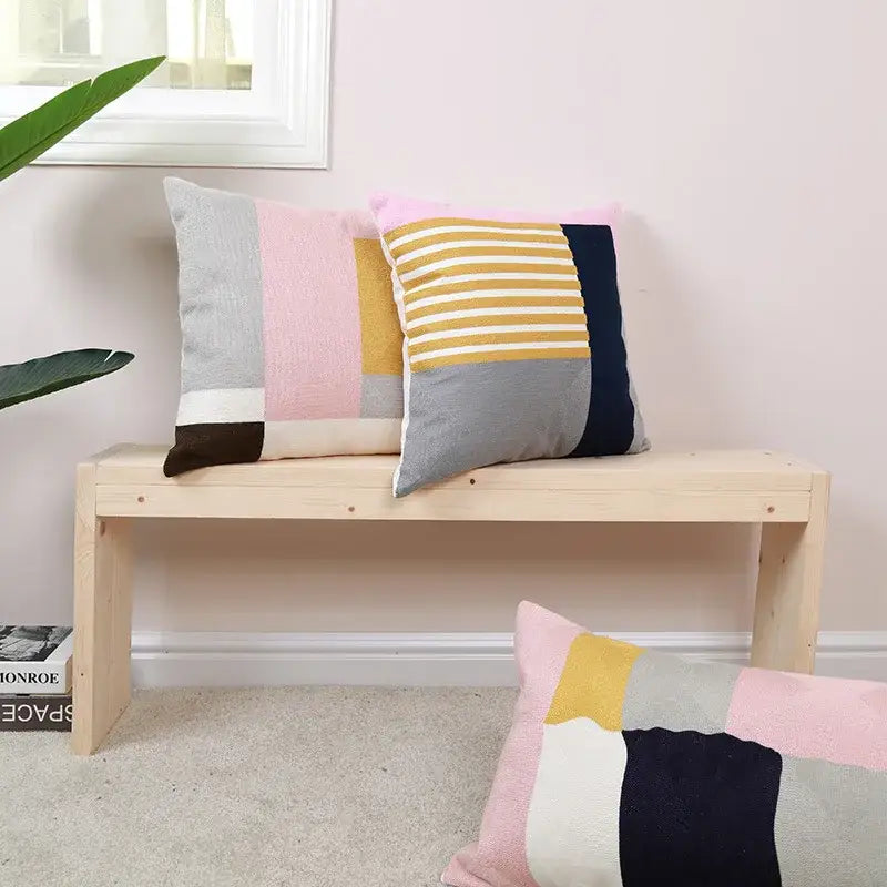 Two rectangular patchwork pillow covers with modern geometric embroidery in yellow gray pink navy and white for living room decor
