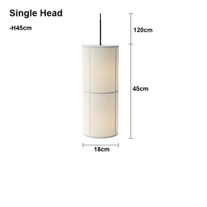 Minimalist cylindrical hashira cluster pendant light with off-white fabric shade and metallic trim for dining room decorbites