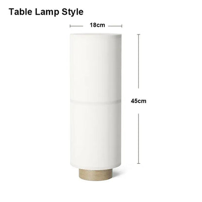 Minimalist white cylindrical table lamp with matte finish and light wood base complementing decorbites hashira cluster pendant light