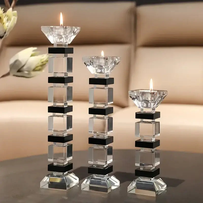 Three crystal candle holders with black square accents and lit candles in modern block design decorbites geometric glass set