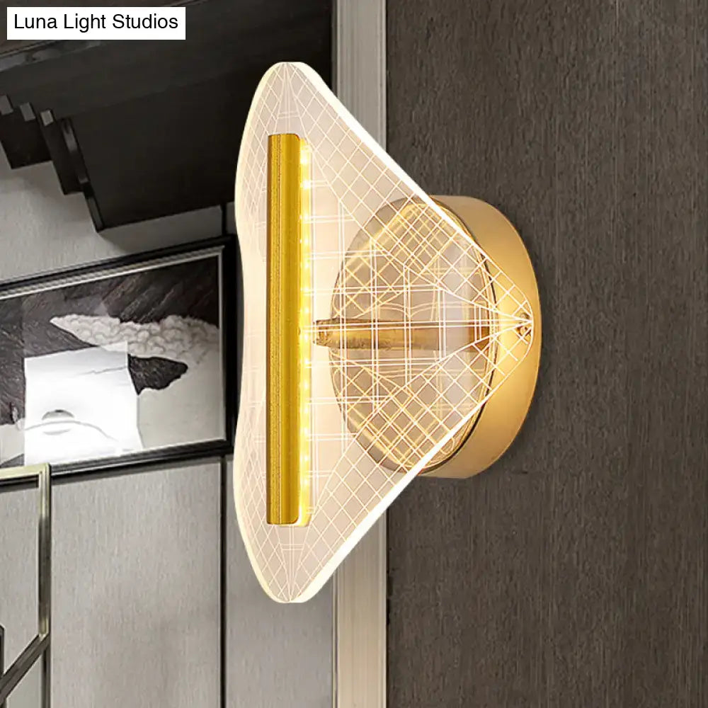Modern geometric gold sconce light with translucent patterned diffuser and illuminated vertical strip for living room