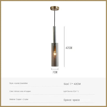 A sleek copper crystal led pendant light with cylindrical glass shade and exposed filament bulb for dining room decorbites