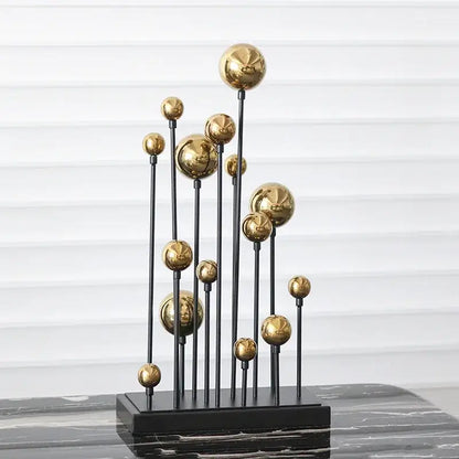 Modern abstract geometric golden ball sculpture with multiple golden spheres on black metal rods for living room decor