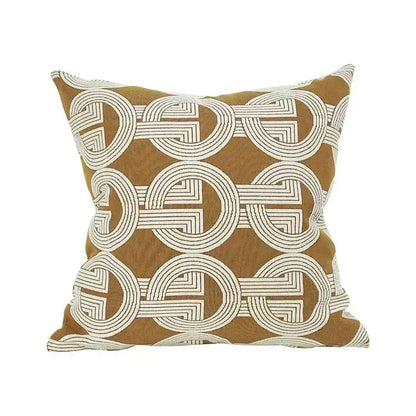 A mustard cushion cover with white embroidered interlocking circles featuring decorbites geometric jacquard design