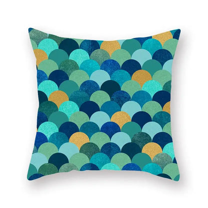 A square throw pillow with vibrant teal blue and gold overlapping scale pattern for decorbites geometric leaf decor
