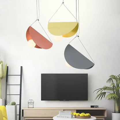 Three modern decorbites geometric led pendant lights with coral, yellow, and gray metallic shades for dining room decor