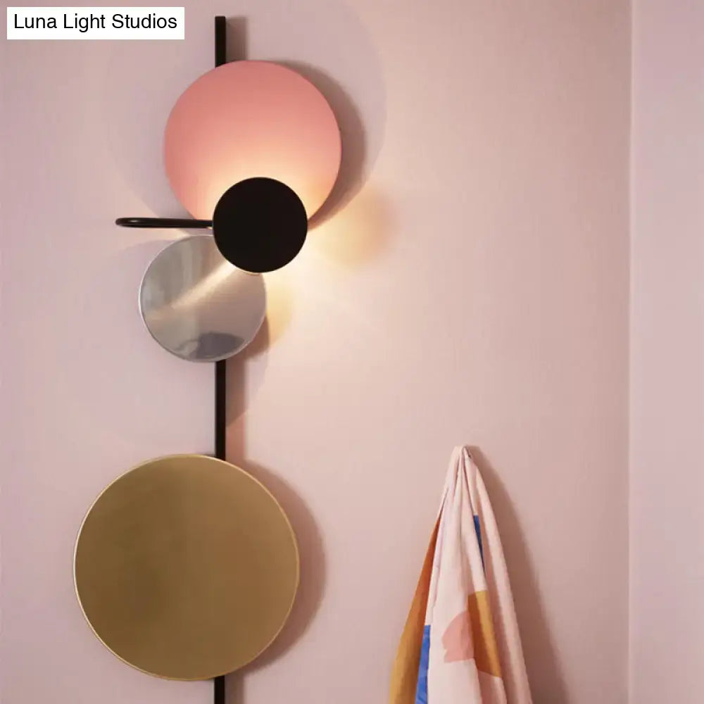 Modern geometric led wall light with stacked circular shades in matte pink black mirrored silver and brushed gold for living room