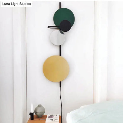 Modern led wall light with stacked discs in matte green black gold and sleek frame for red pink blue living room sconce