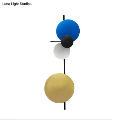 Modern geometric led wall light living room sconce with four blue, black, white, and gold spherical shades on black rod