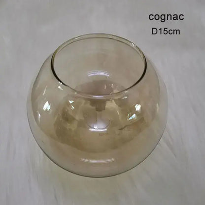 A translucent cognac-colored glass bowl with a smooth rounded shape and wide rim for modern magic bean lighting