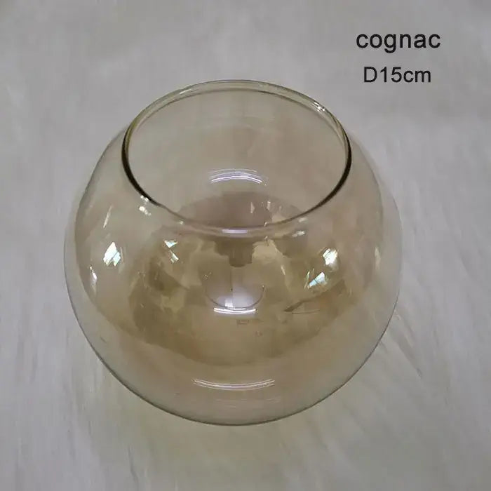 A translucent cognac-colored glass bowl with a smooth rounded shape and wide rim for modern magic bean lighting