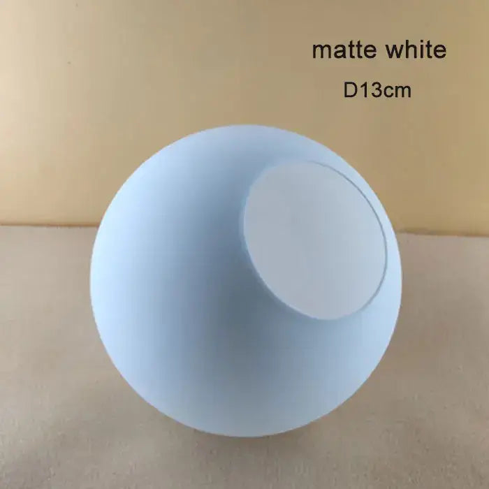 Matte white spherical lampshade with frosted finish and circular opening for modern geometric magic bean lighting