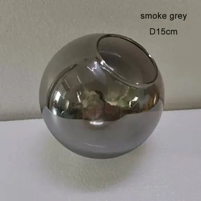 Smoke grey spherical glass vase with smooth reflective surface and asymmetrical opening in modern magic bean lighting
