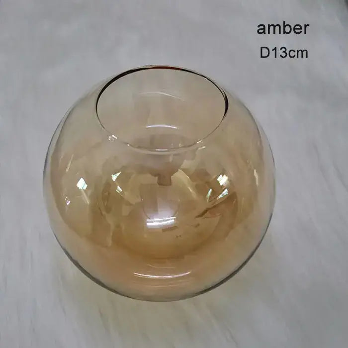Amber-colored glass bowl with smooth rounded shape and clear rim for modern geometric magic bean lighting dining globe