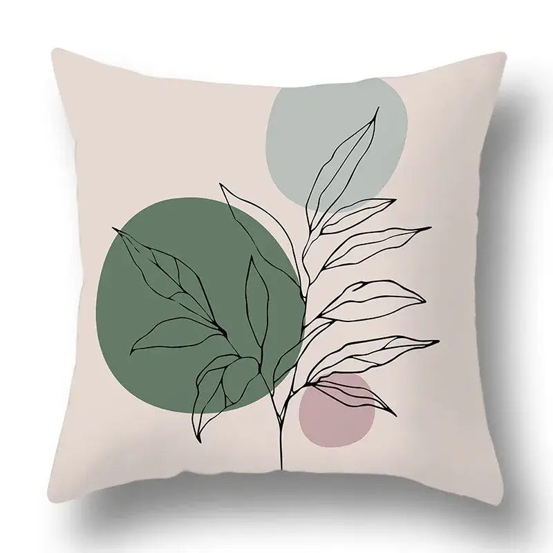Beige pillow cover with geometric print of black line-drawn green plants on soft green gray and dusty rose circles for decorbites